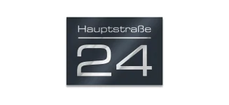 Moderne Hausnummer aus Edelstahl an einer Hauswand montiert